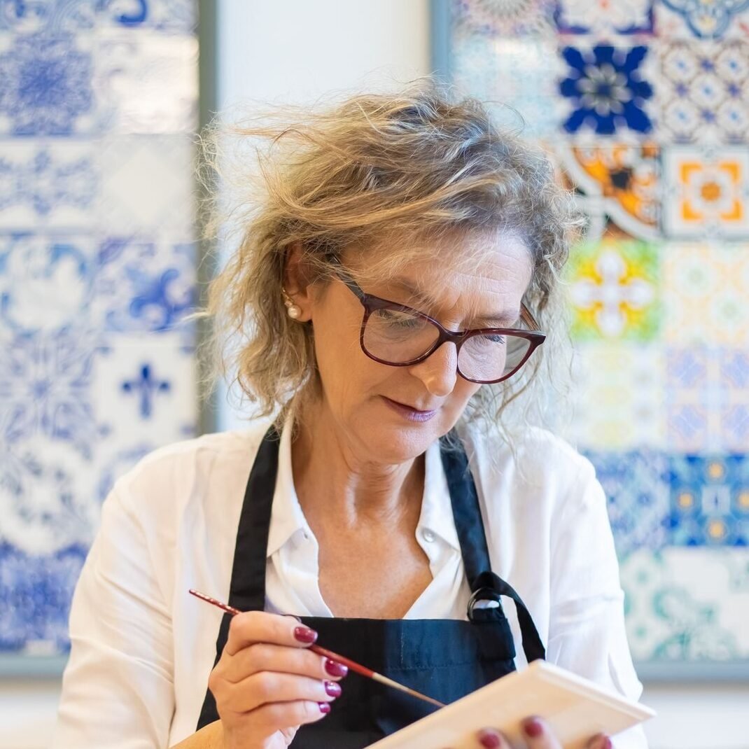 Senior woman creating ceramic artwork in a studio in