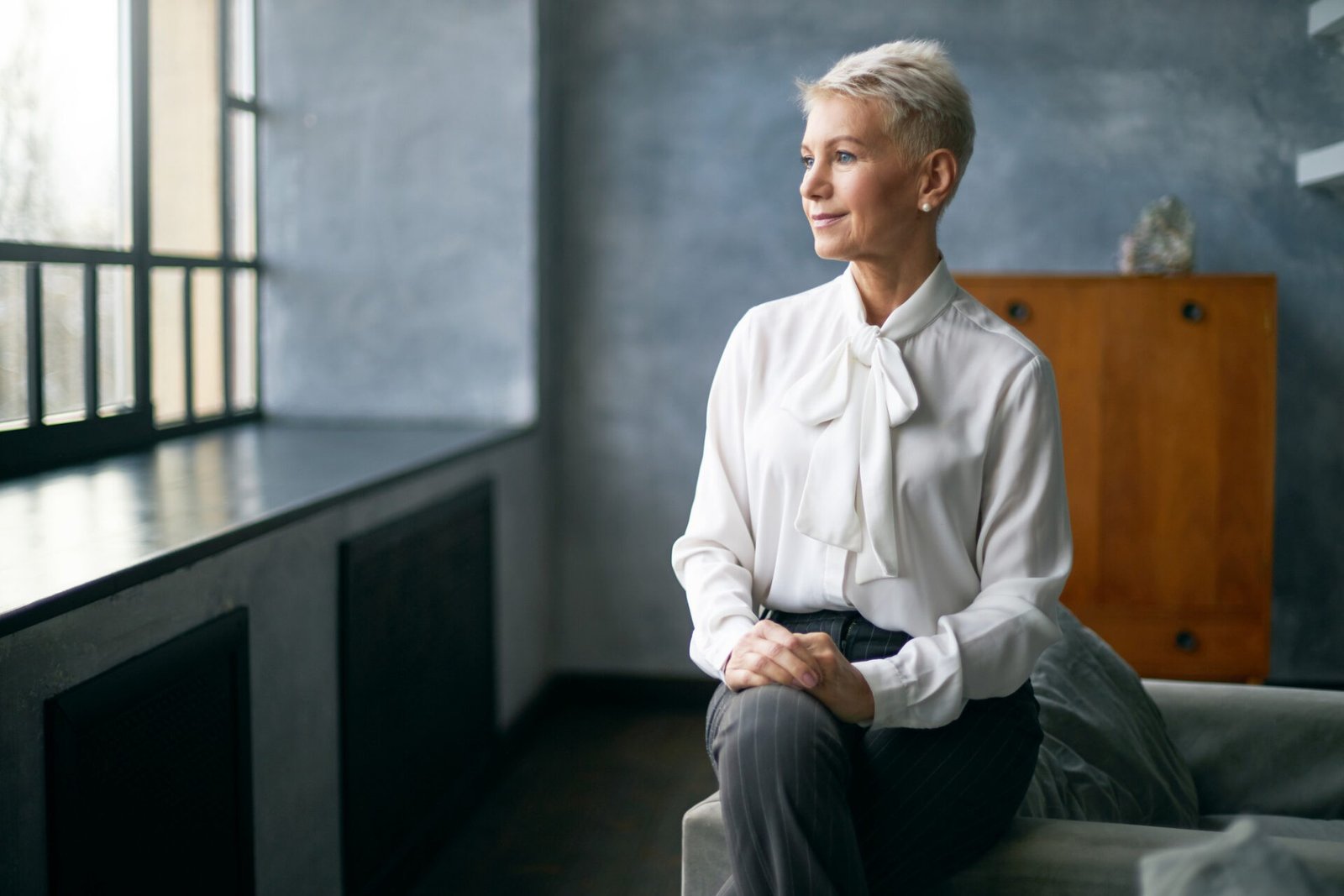 Woman reflecting on years of experience while planning to turn skills into income Woman reflecting on years of experience while planning to turn skills into income
